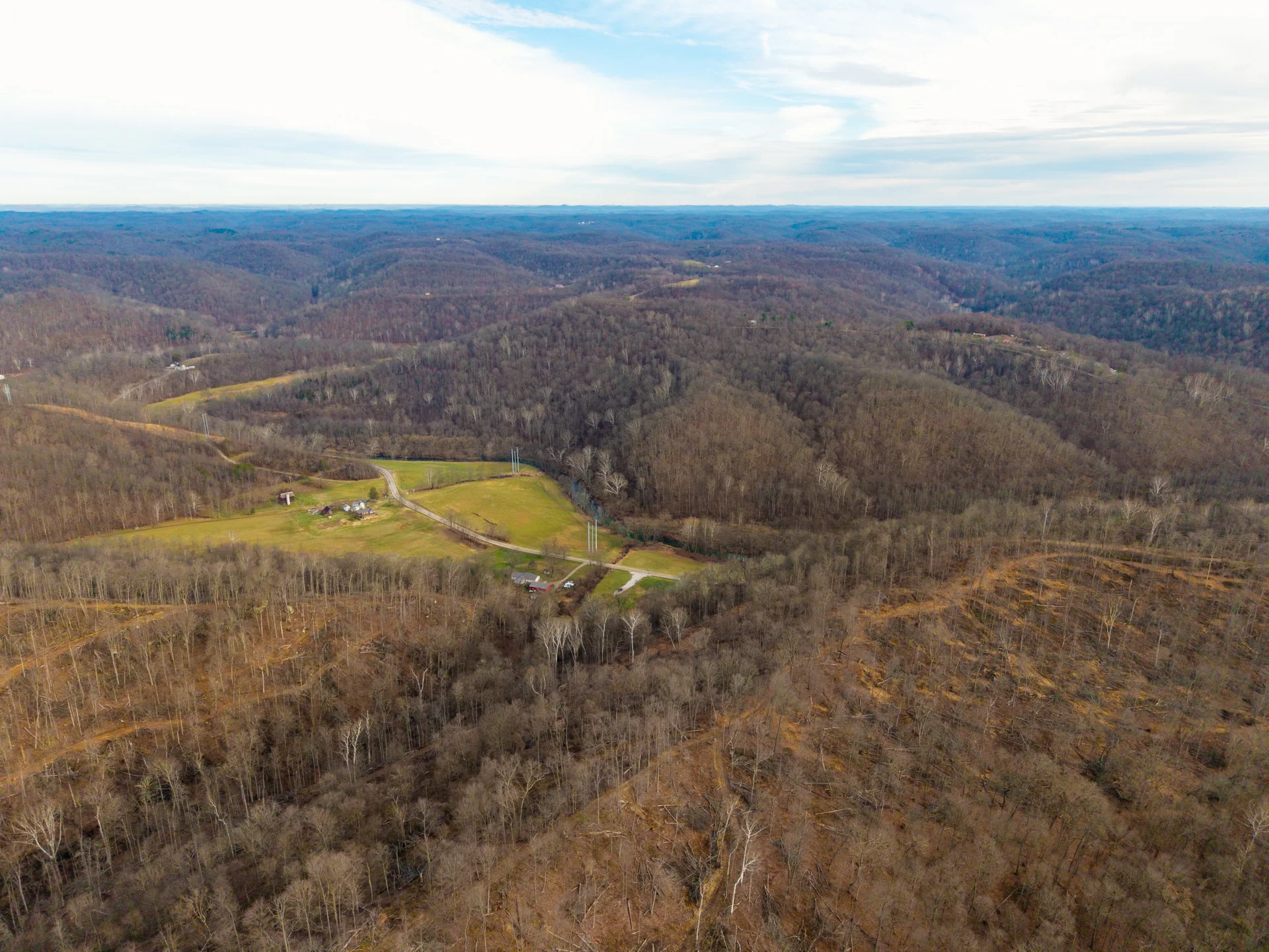 Aerial view of rolling hills and timber in Washington County, Ohio — the heart of M&M Land Company's service area
